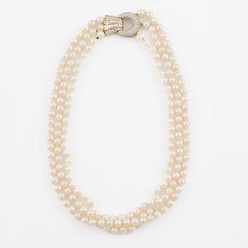 Pearl necklace, three strands of cultured pearls, clasp in 18K gold set with baguette and brilliant-cut diamonds.