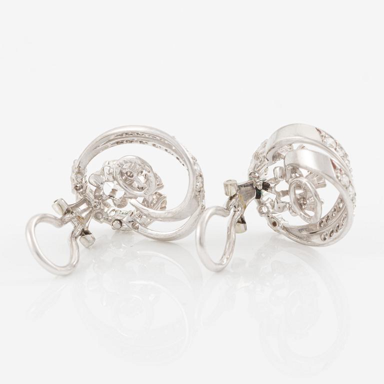 A pair of earrings in 18K white gold set with round brilliant-cut diamonds.