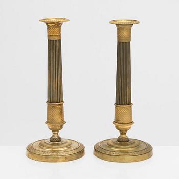 A pair of Empire style candlesticks, early 19th century.