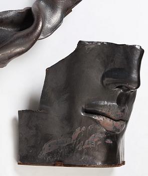 Hertha Hillfon, a black glazed stoneware wall sculpture in two parts of a face and a sky, executed in her own studio, Stockholm 1960s.