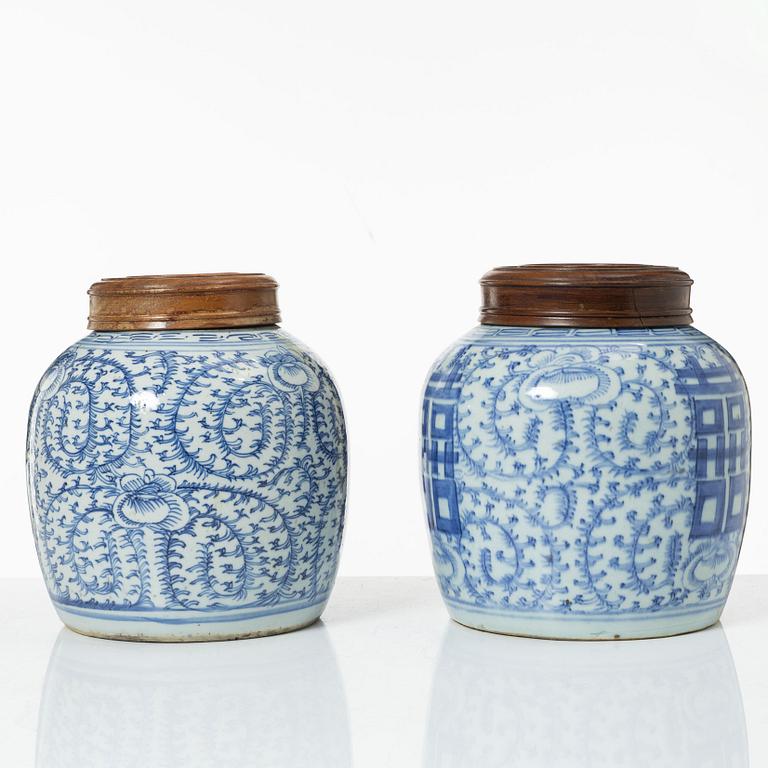 Two similar Chinese blue and white porcealin jars with wooden covers, Qing dynasty, 19th Century.