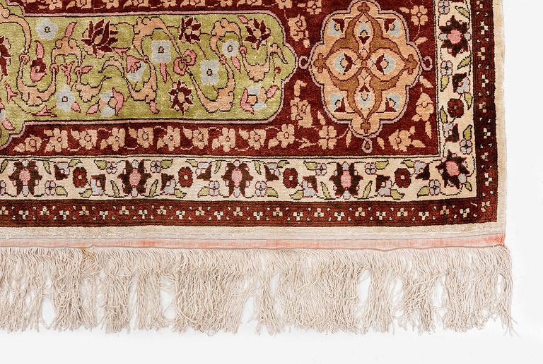 A semi-antique Turkish silk rug, c. 200 x 130 cm.