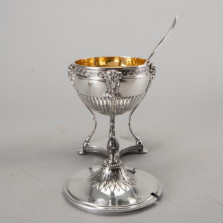 A silver bowl on foot, a pair of candlesticks and a spoon. early 20th century. Total weight app. 800 gram.