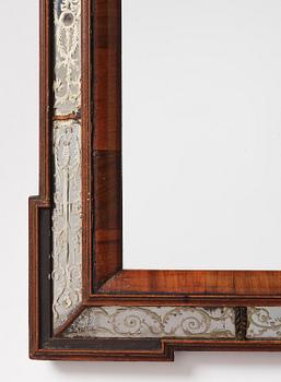 A Dutch Baroque walnut, engraved and reverse glass painted mirror, early 18th century.