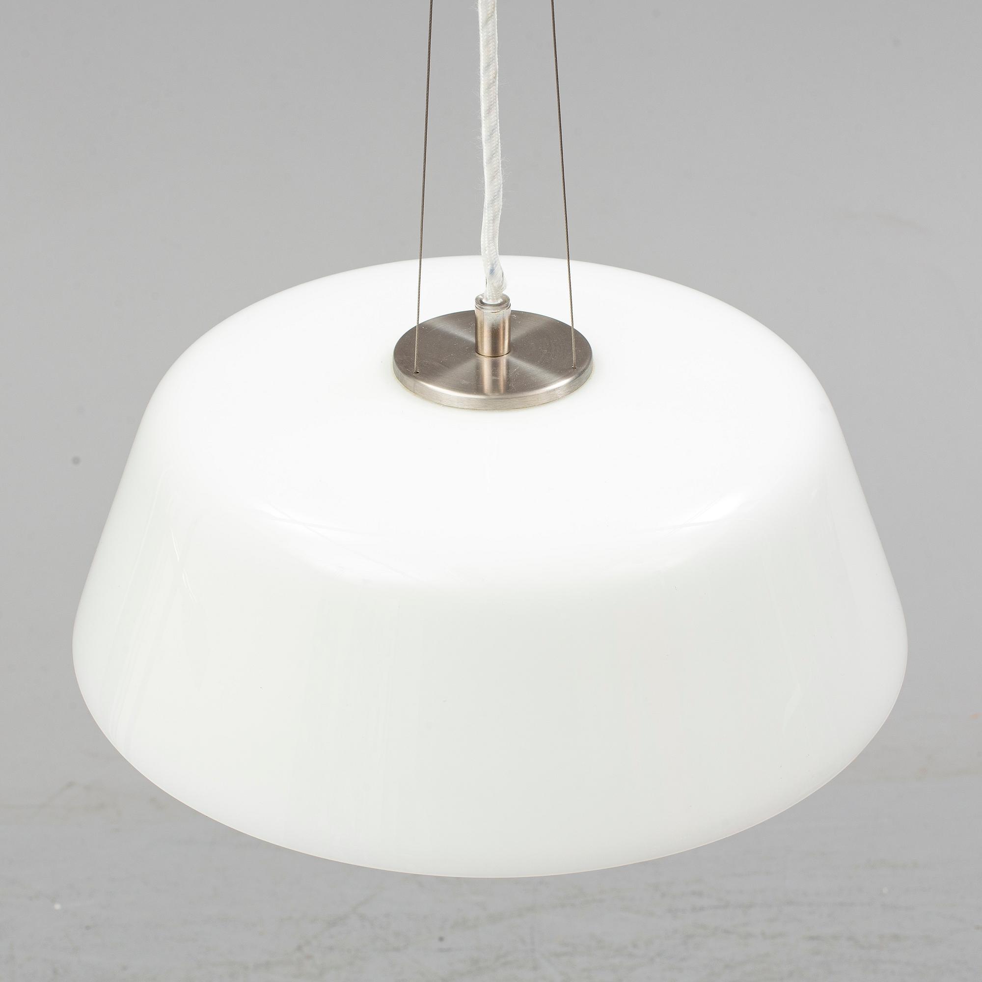 An Arne Jacobsen "Centenary Package" comprising three "Ant Chairs" and an eggshaped table, Fritz Hansen, Denmark.