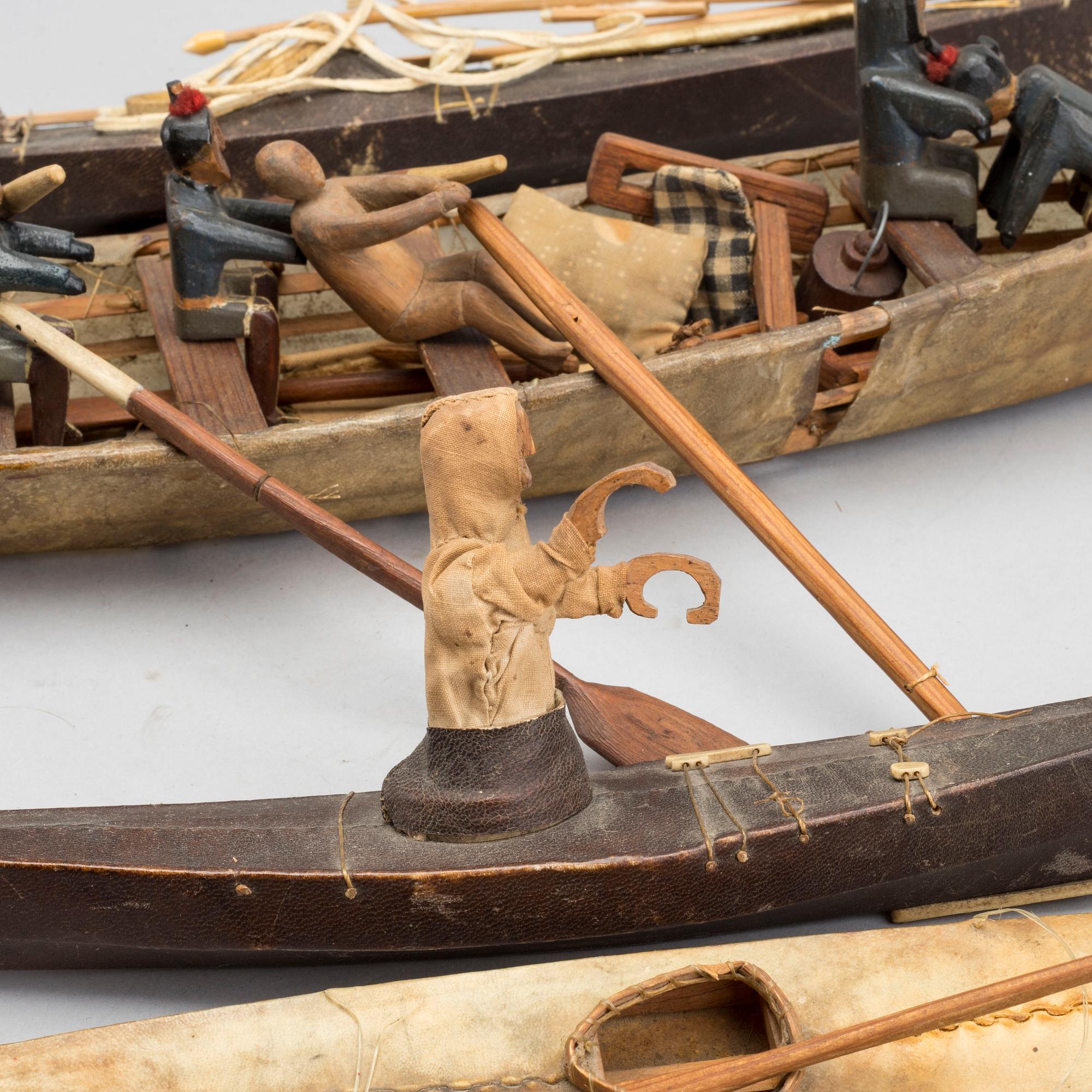 AN UMIAK AND THREE KAJAKS, MODEL BOATS GREENLAND, WITH FIGURES, PADDLES, SPEERS ETC.