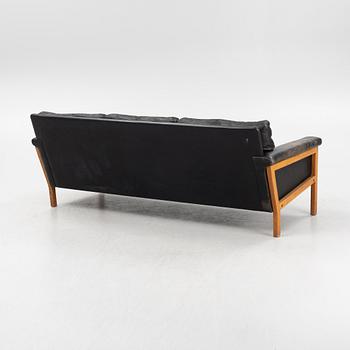A leather and teak sofa, 1960-70s.