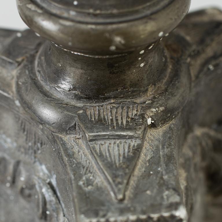 A pair of baroque pewter candlesticks, engraved date 1699.