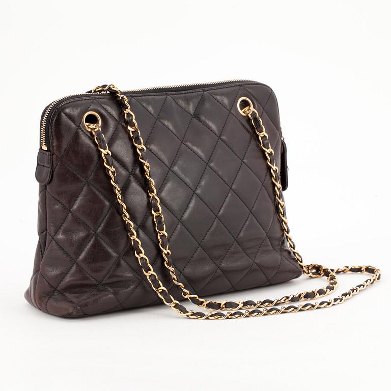 CHANEL, a quilted dark brown leather shoulder bag.