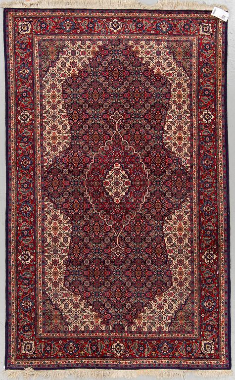 An oriental rug, around 204 x 125 cm.