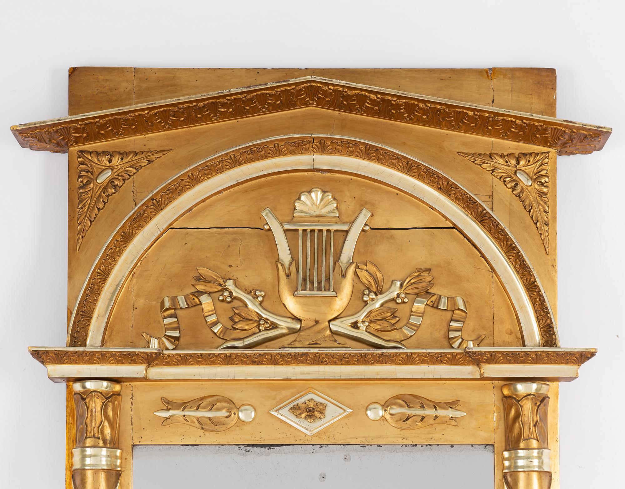 An Empire mirror, first half of the 19th century.