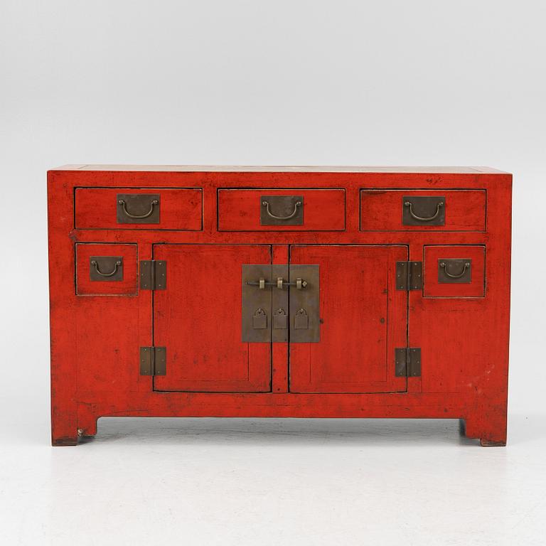 A Chinese red lacquered cabinet, 20th century.