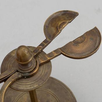 A 18th Century brass candle holder.