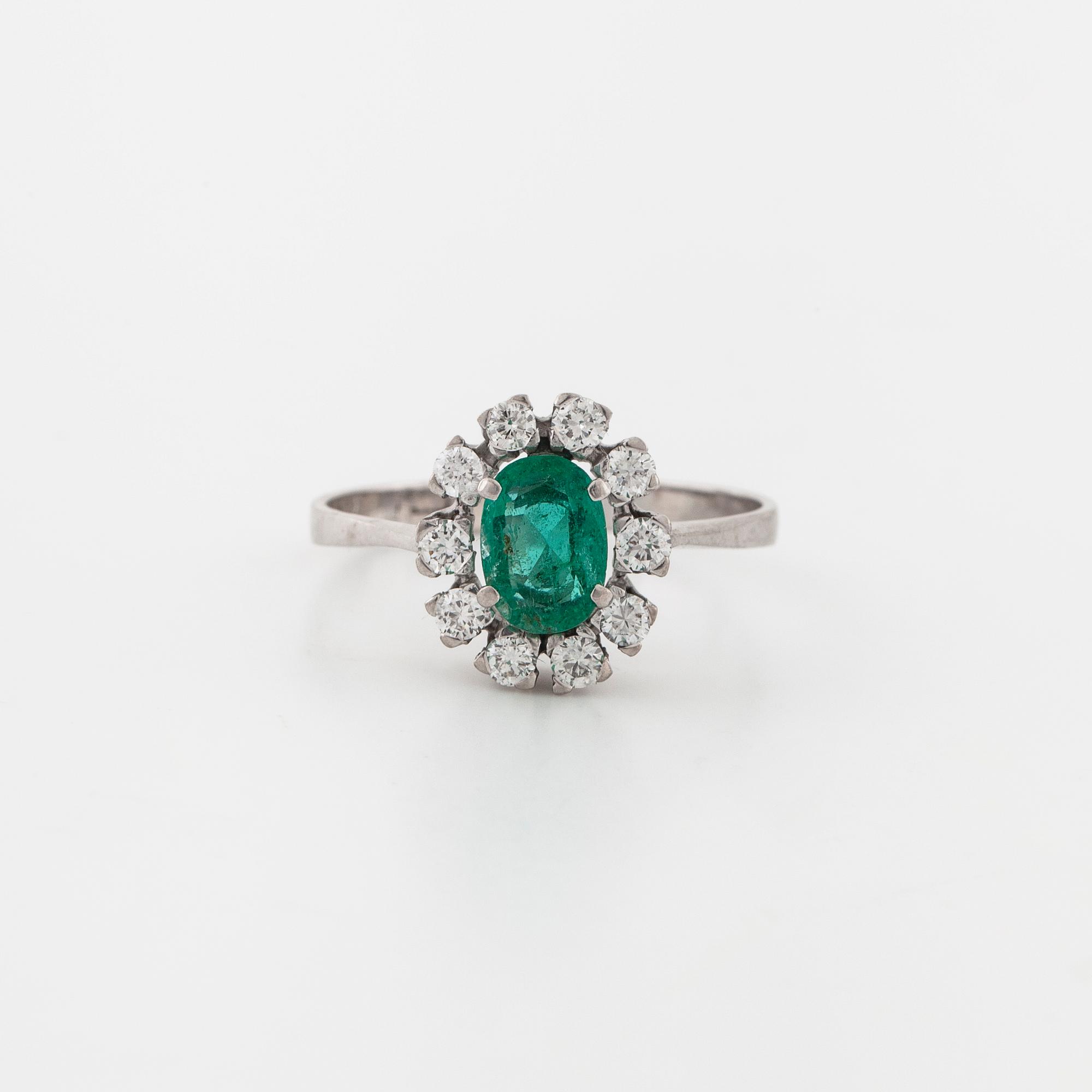 A emerald and brilliant cut diamond ring.