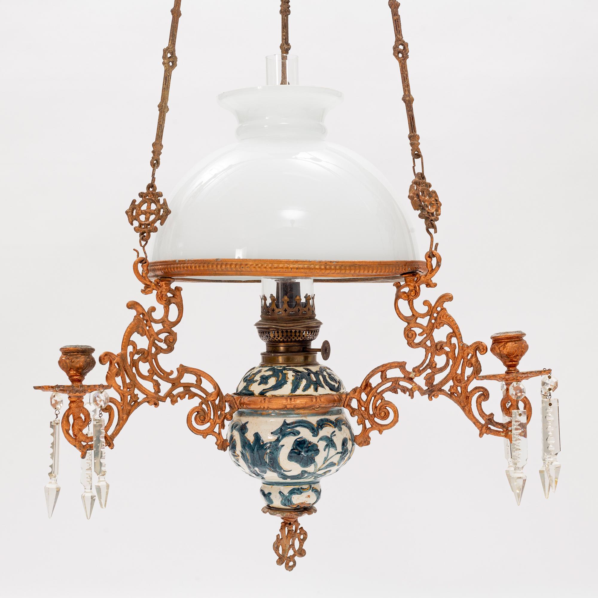 A ceiling carosene lamp, circa 1900.
