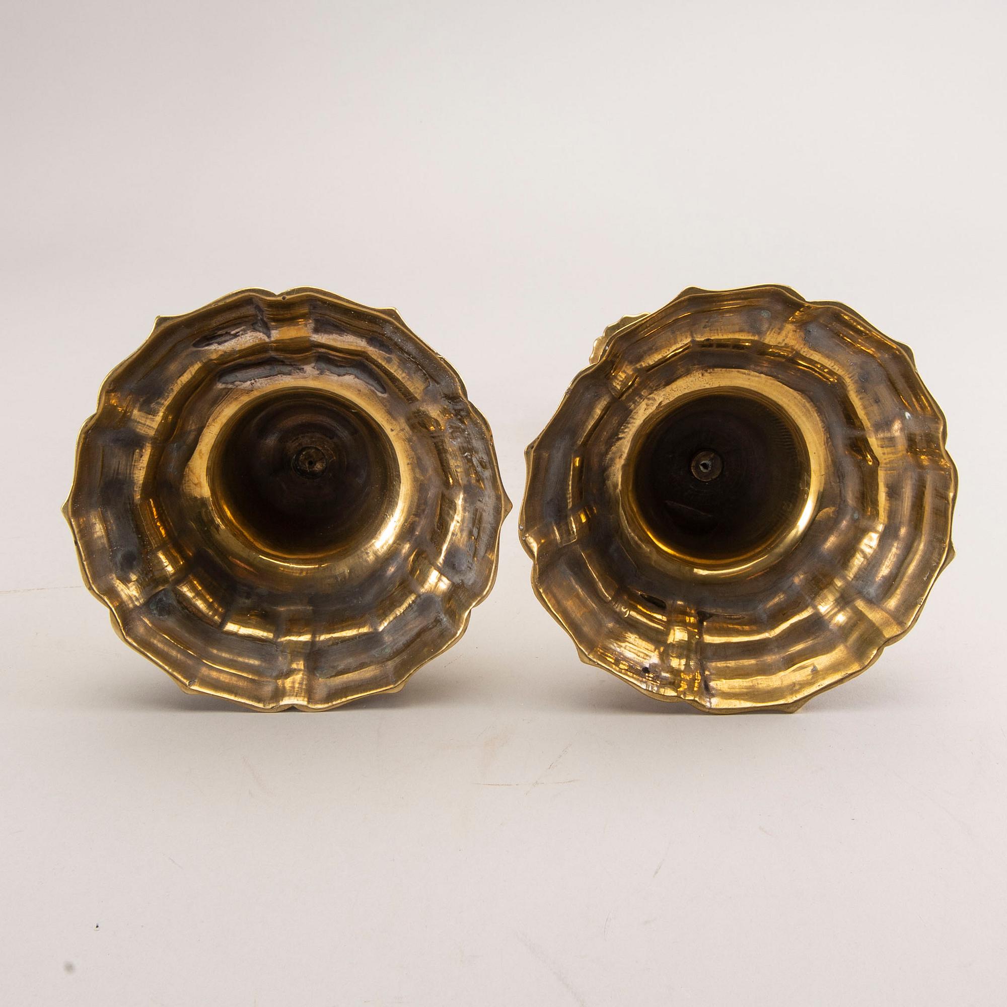 A pair of rococo brass candlesticks, possibly France.