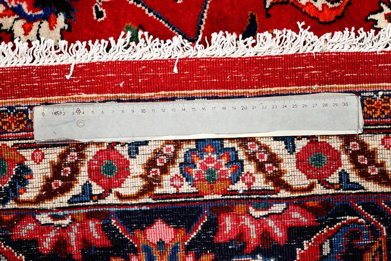 A SIGNED MESHED RUG, 392 x 305 cm.