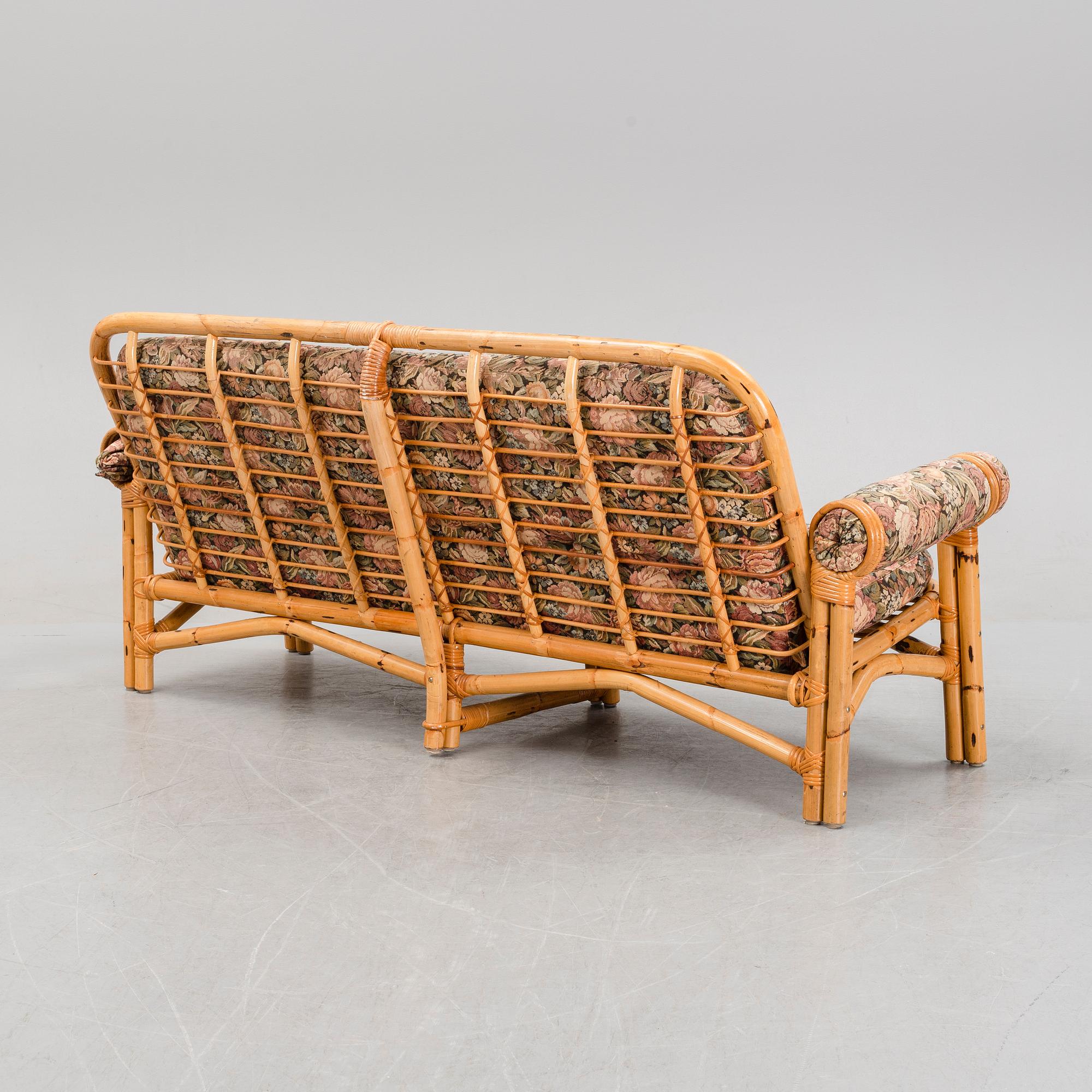 A set of two garden sofas, an armchair and a glass table, later part of the 20th Century.