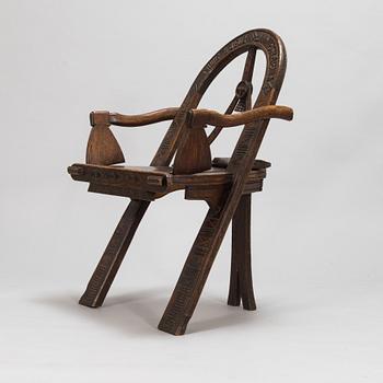 A carved oak wood armchair after V.P. Shutov's design "Arch, axe and gloves", Russia, late 19th century.