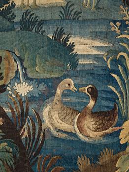 A TAPESTRY, tapestry weave, a "Verdure",  ca 304 x 224,5 cm, Flanders 17th century, signed "W" a lily "B".