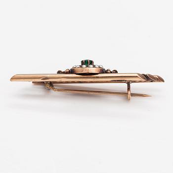 A 14K gold brooch with pearls and garnet glass doublet.