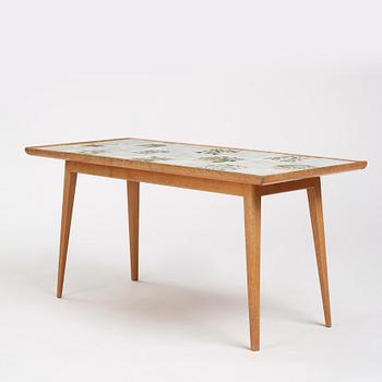 a Swedish Modern coffee table, decorated with Jobs' ceramic tiles, signed and dated 1941.