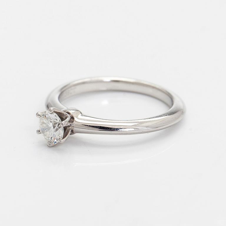 Tiffany & Co, a platinum solitaire ring with a brilliant-cut diamond.