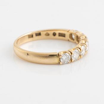 An 18K gold ring set with round brilliant-cut diamonds.