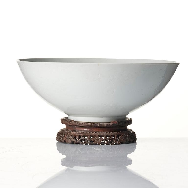 A large white glazed anhua decorated five clawed dragon bowl, Qing dynasty, Yongzheng mark and of the period (1723-35).