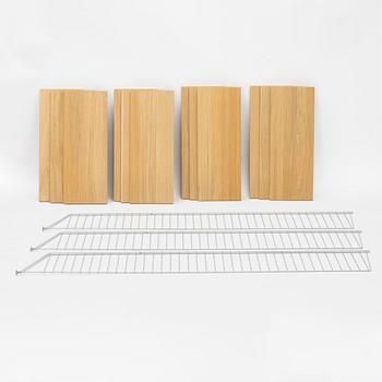 A 'String' shelving system by Nils Strinning, with three sides and 12 shelves.