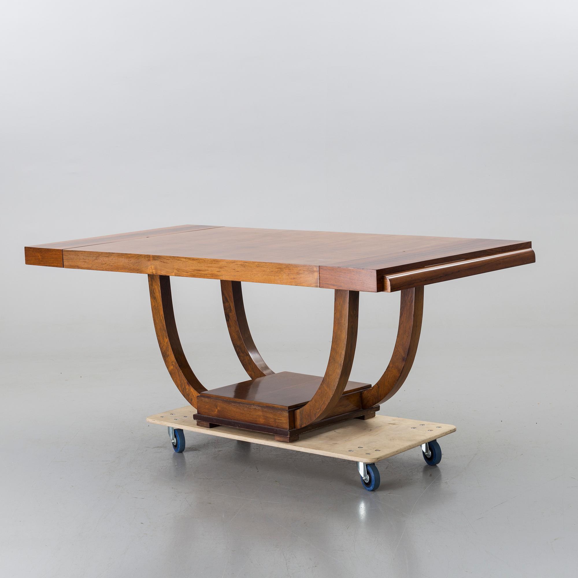 A french art deco dining table with extra boards.
