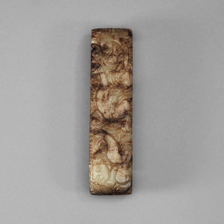 A carved white and brown mottled nephrite scabbard clasp (zhi), Qing dynasty (1644-1912).