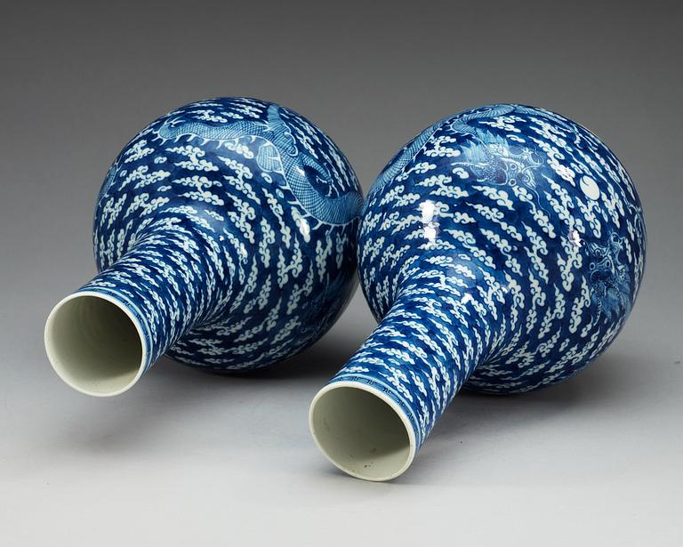 A pair of blue and white vases, late Qing dynasty, with Kangxi four character mark.