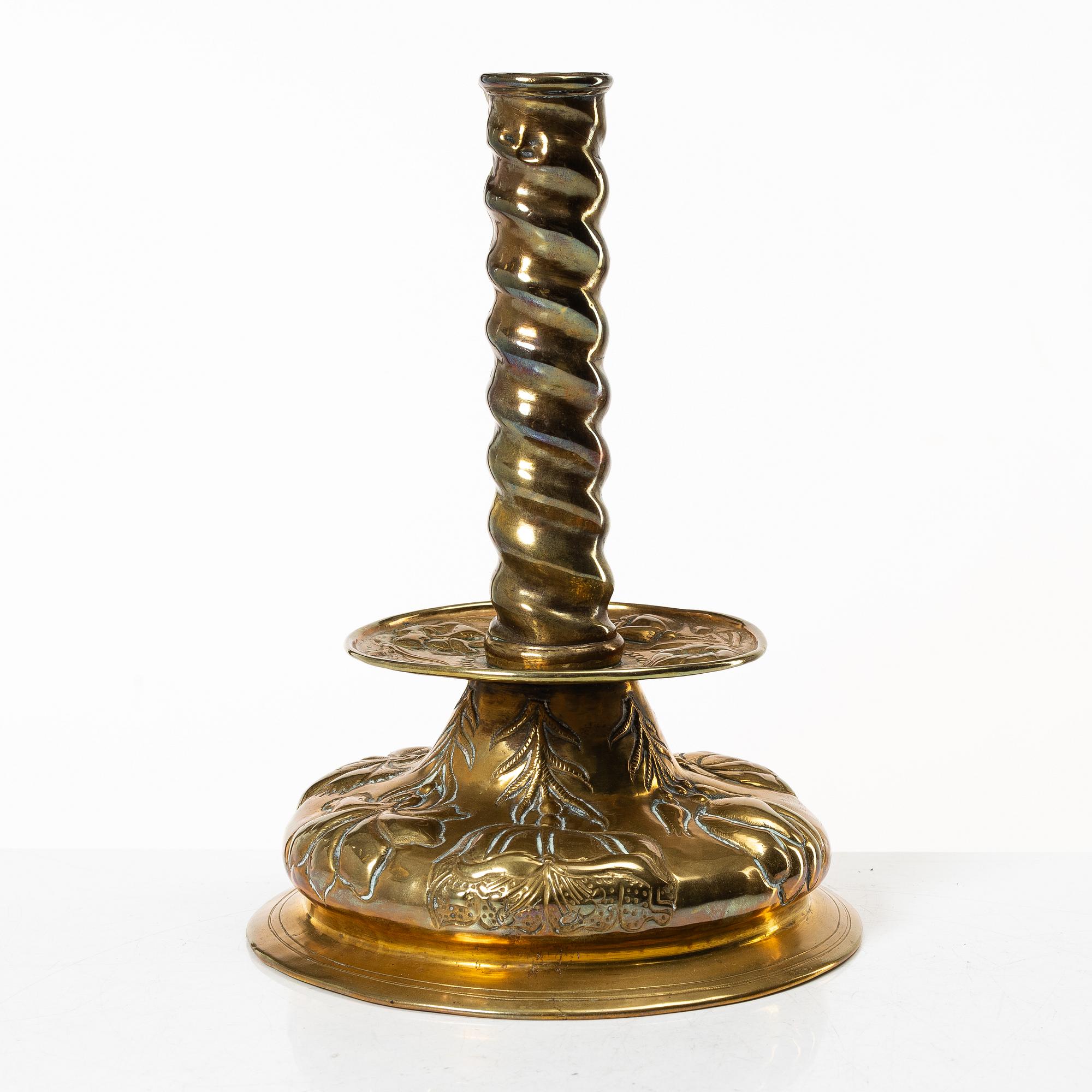 A Baroque brass candle stick, 18th century.
