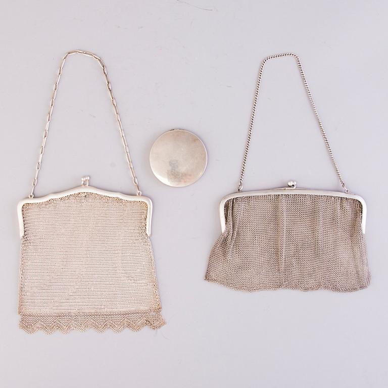 Two silver evening bags and a silver mirror, 1920s-1940s.