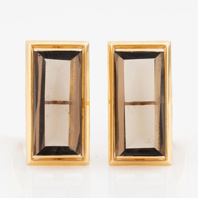 A pair of cufflinks in 18K gold with smoky quartz.