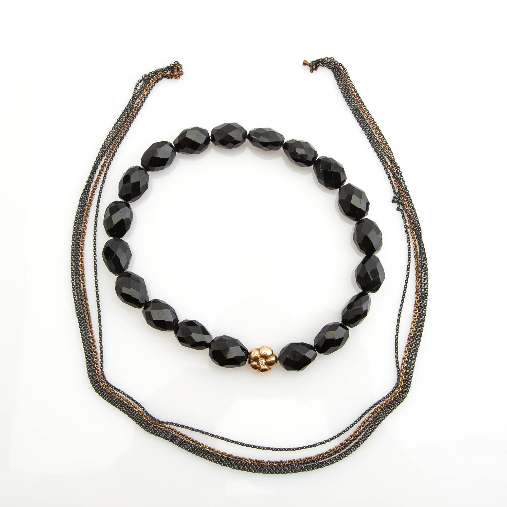 Ole Lynggaard, clasp, 18K gold with a round brilliant-cut diamond, and two necklaces.