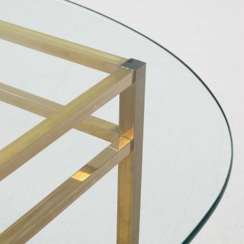 A 1970's glass and brass coffee table.