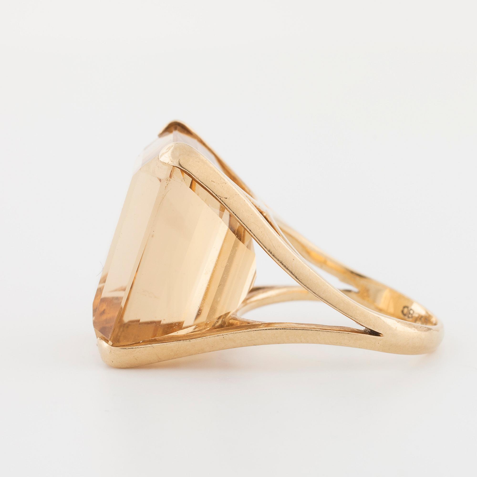 An emerald cut citrin ring.