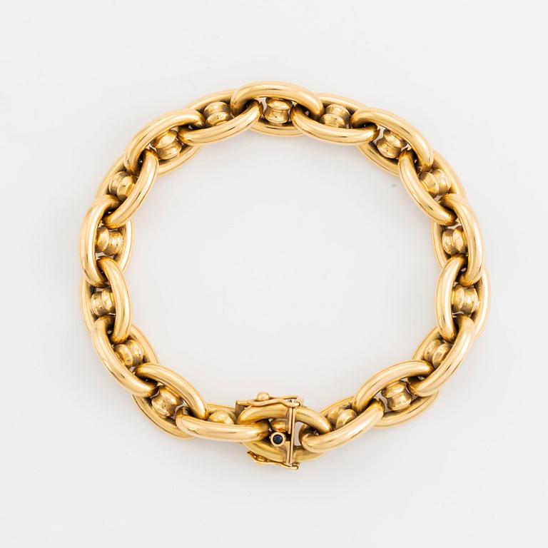An 18K gold bracelet.