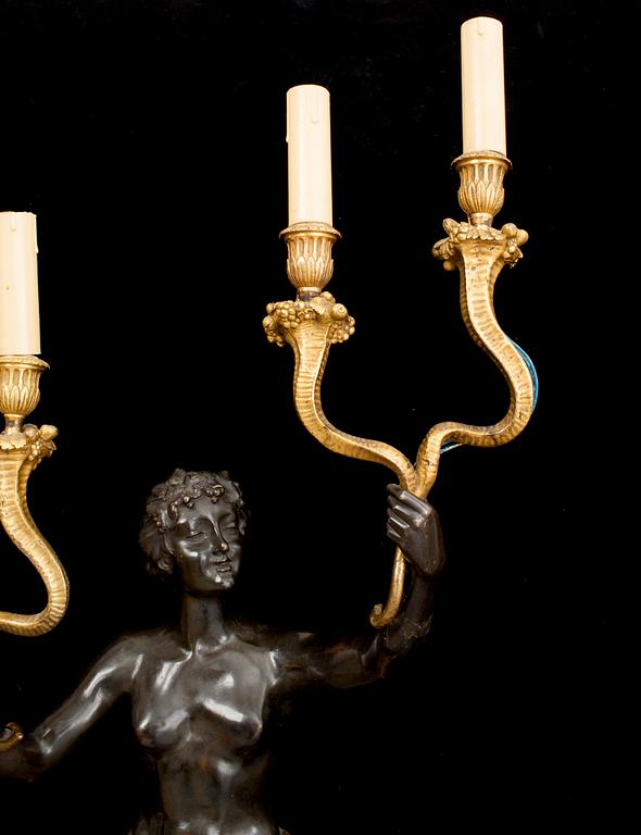 A pair of Louis Philippe 1830/1840's gilt and patinated bronze four-light wall-lights.