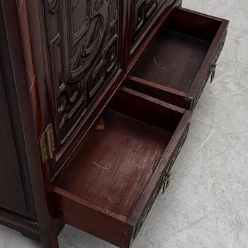 A small Chinese stained wood two part cabinet, 1900s.