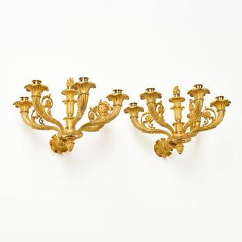 A pair of French Empire six-branch ormolu appliques, ca 1820's.