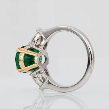 An emerald, circa 3.85 cts and diamond, circa 1.00 ct in total, ring.