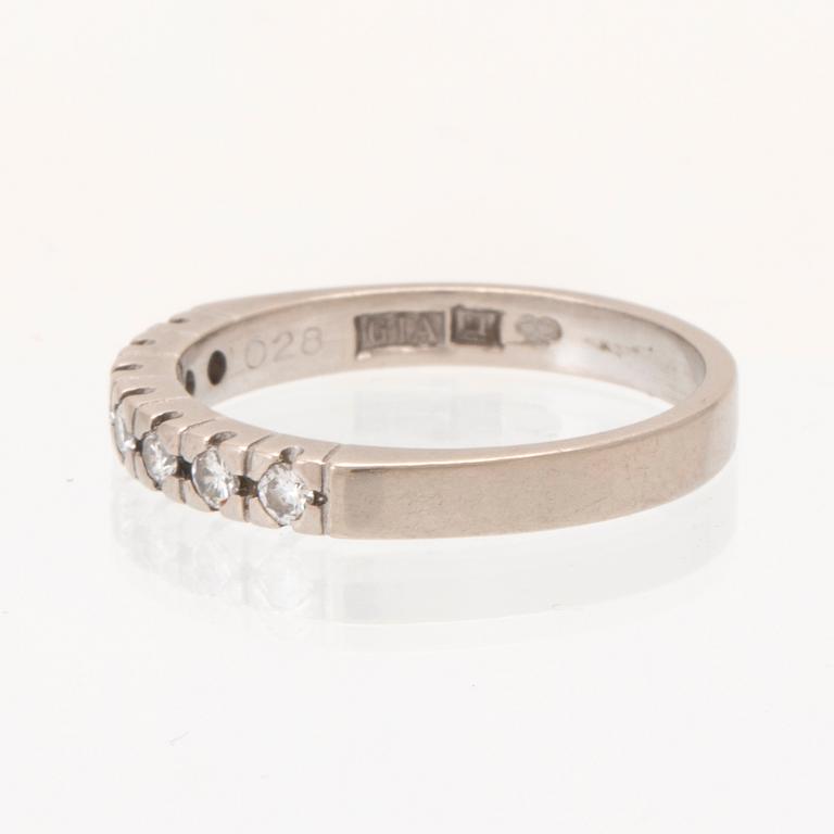 A half eternity ring in 18K white gold set with round brilliant-cut diamonds.