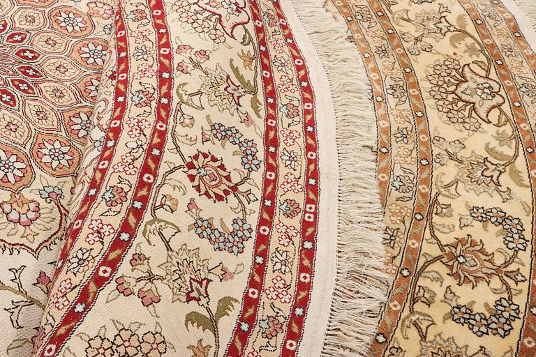 An oriental silk rug, diameter c. 216 cm.