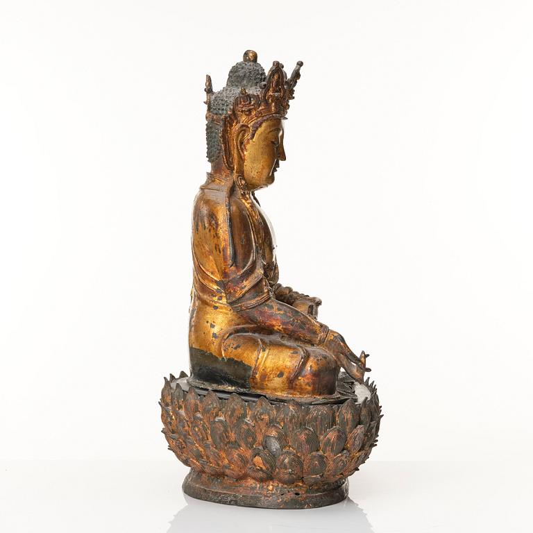 A large cold gilt sculpture of a crowned medicine Buddha/Bhaisjyaguru, Ming dynasty (1368-1644).