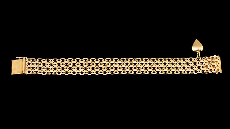 ARMBAND, 18k guld, länk med en berlock, Stockholm, 1958. Vikt 40 g.
