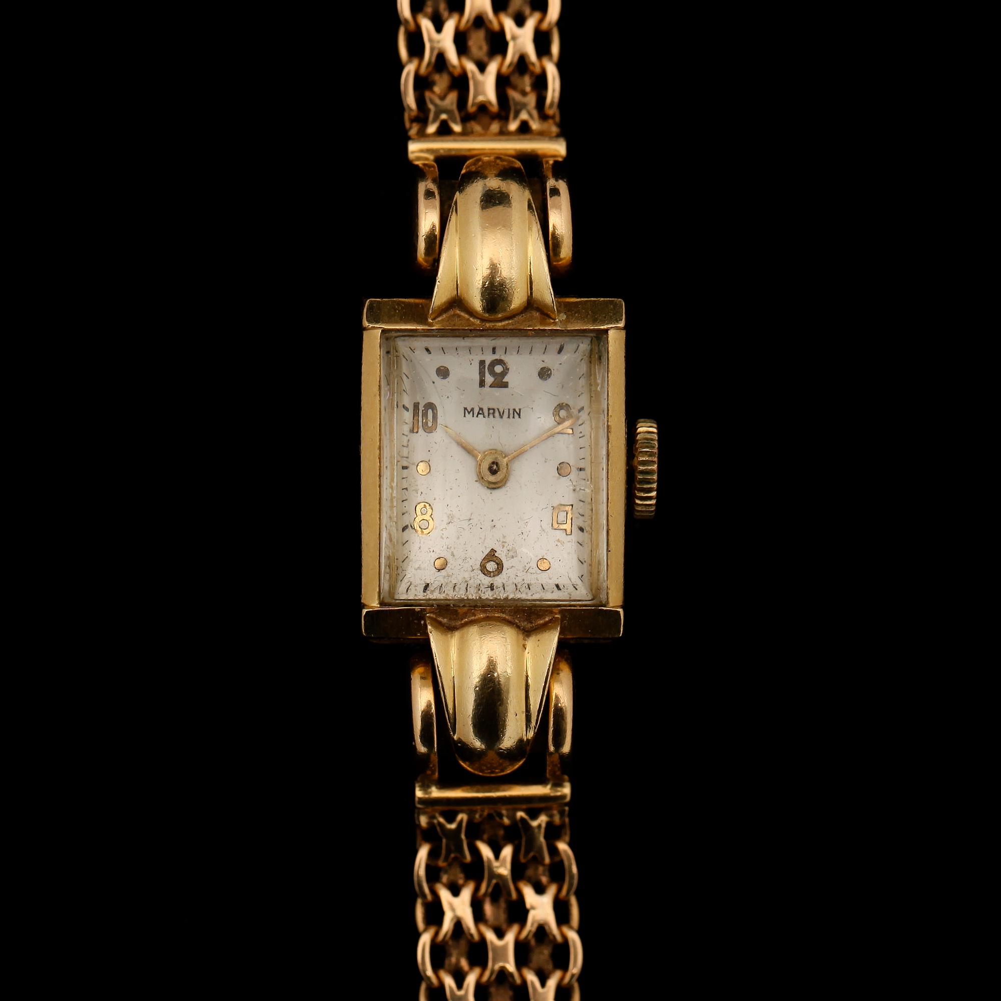 ARMBANDSUR, 18K guld, Marvin, 1900-talets mitt. Total vikt ca 26 g.