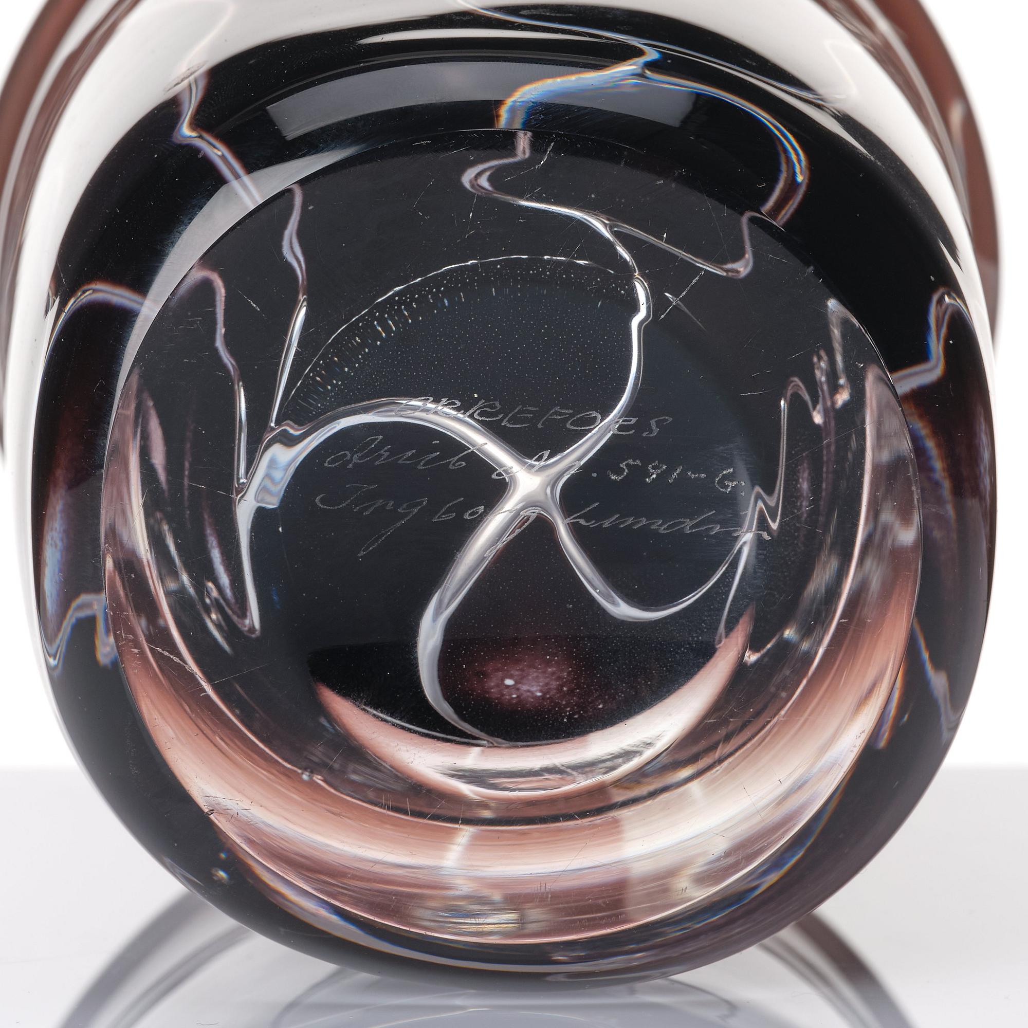 Ingeborg Lundin, an 'ariel' burgundy coloured glass vase decorated with faces, Orrefors Sweden 1972.